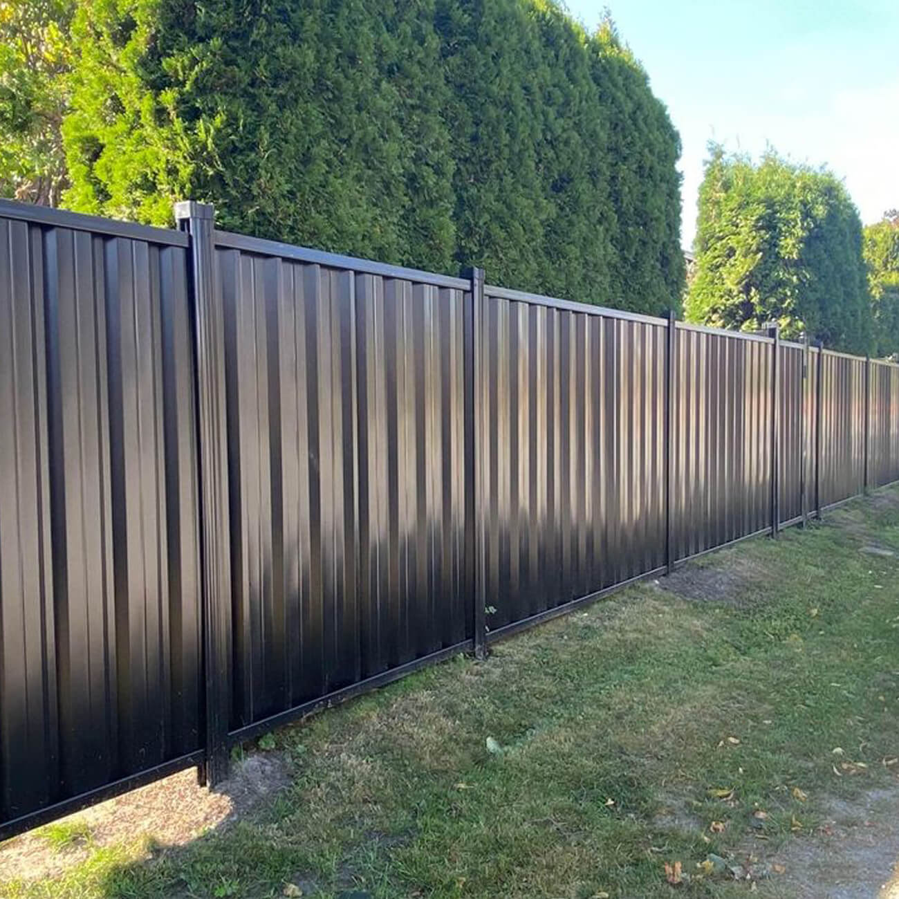 black corrugated metal fence panel